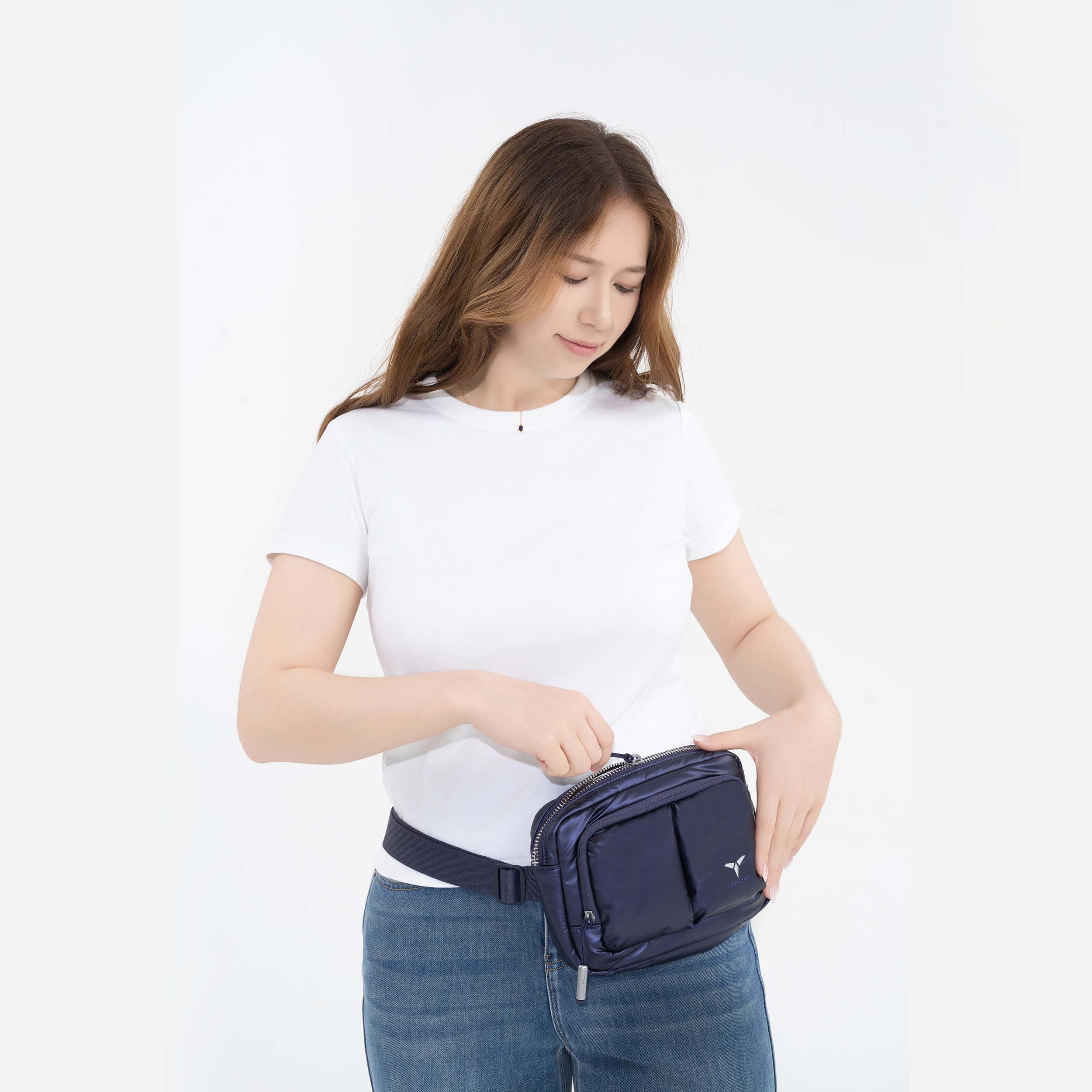 Tesport Cloud Crossbody Belt Bag in Navy female model unzipping