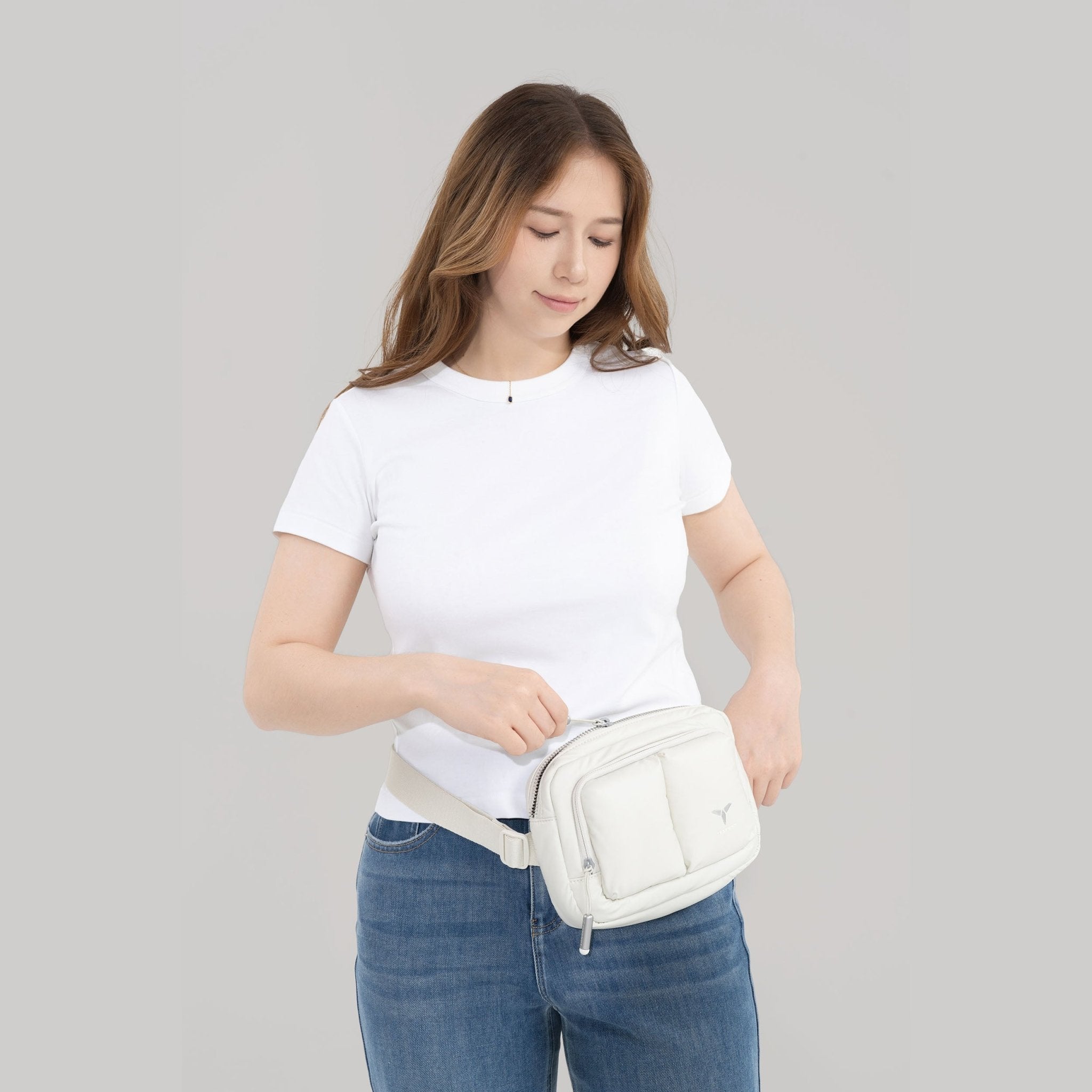 Tesport Cloud Crossbody Belt Bag in White female model unzipping