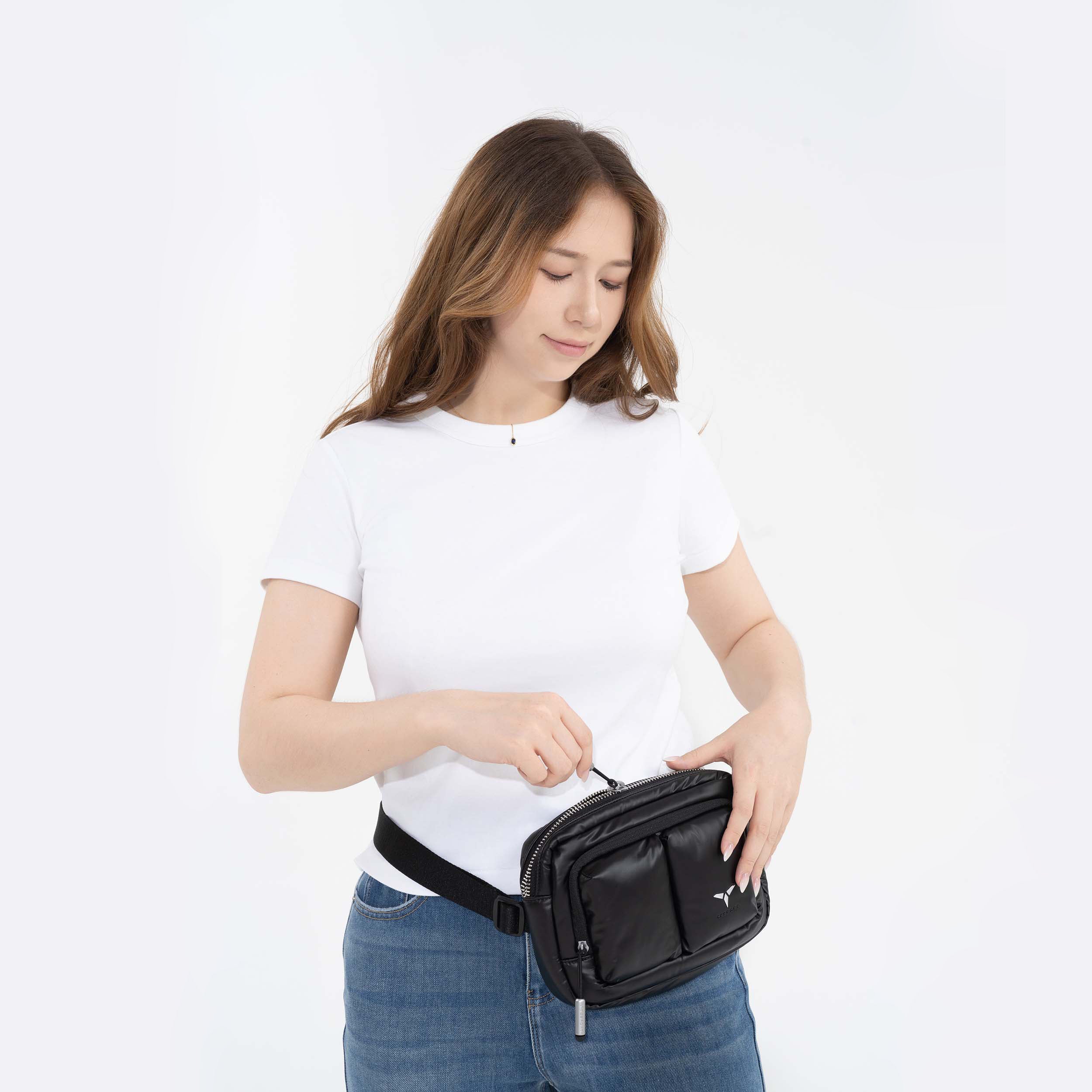 Tesport Cloud Crossbody Belt Bag in Black with female model unzipping
