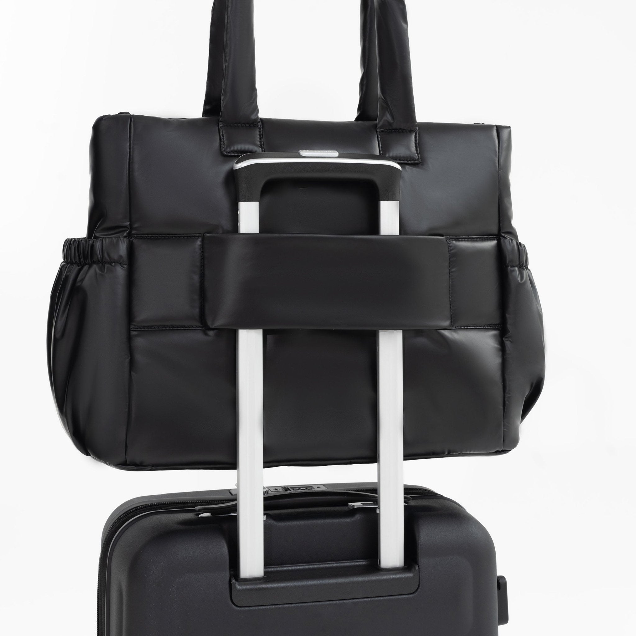 Tesport Cloud Tote in Black on top of other luggage