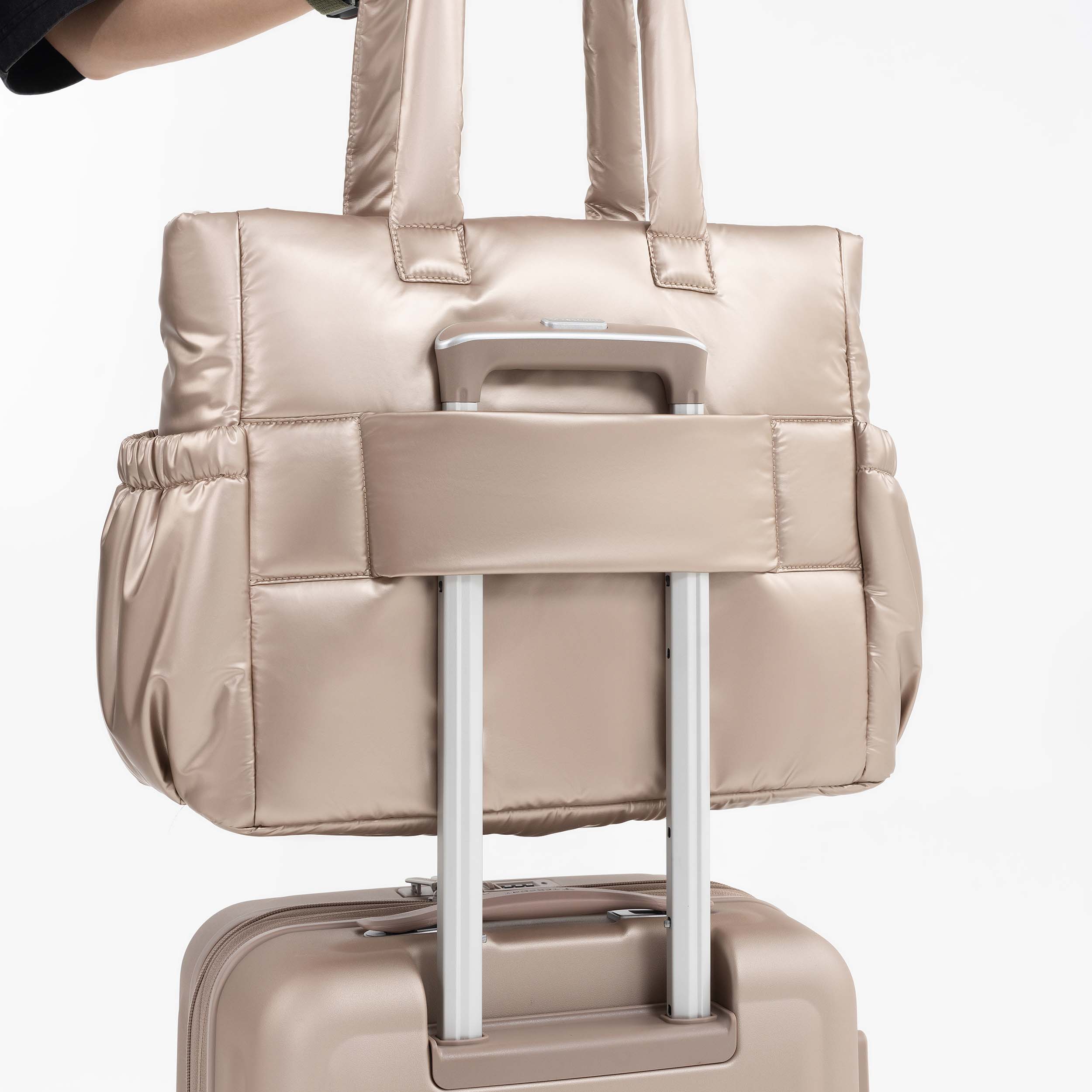 Tesport Cloud Tote in Champagne on top of other luggage