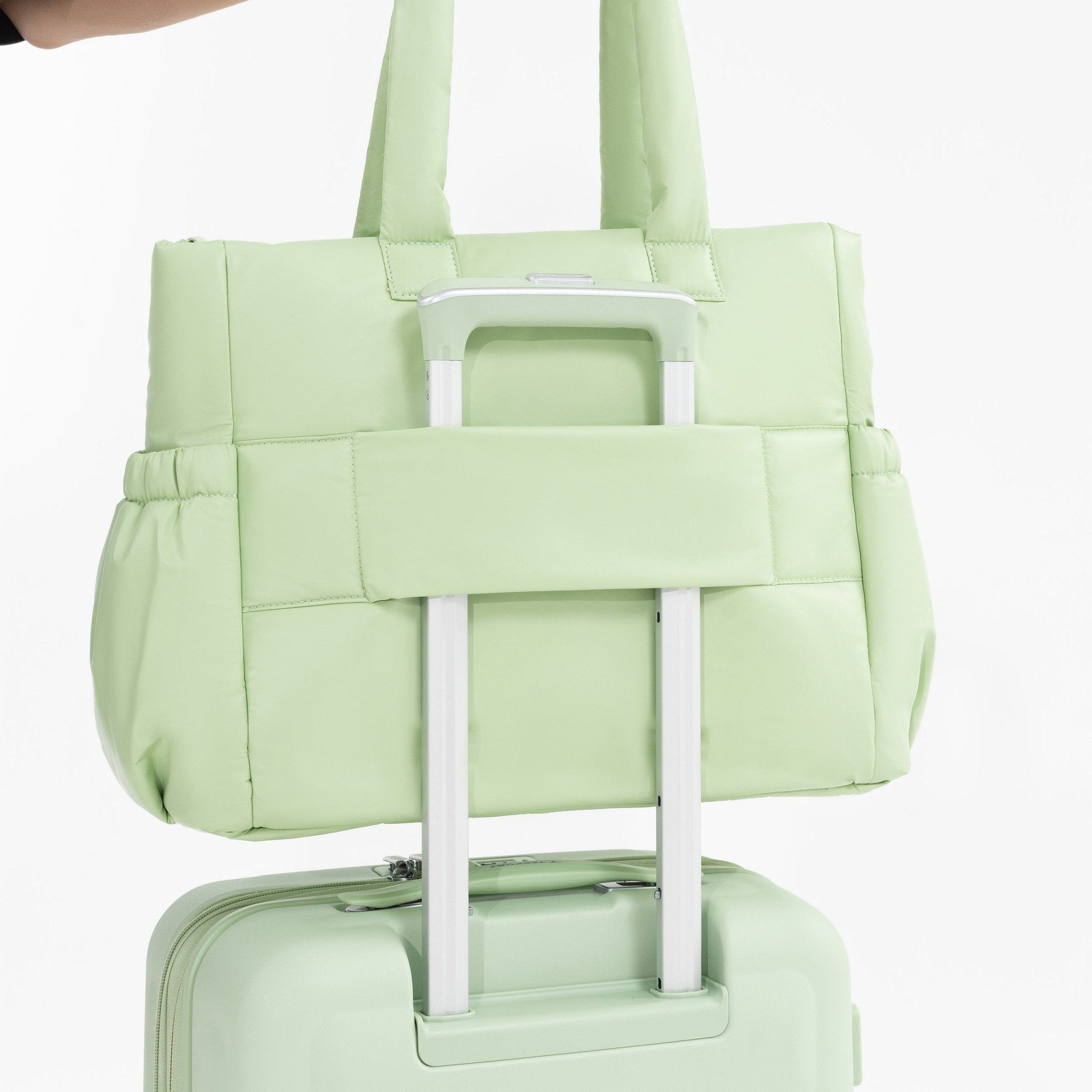 Tesport Cloud Tote in Apple Green on top of other luggage