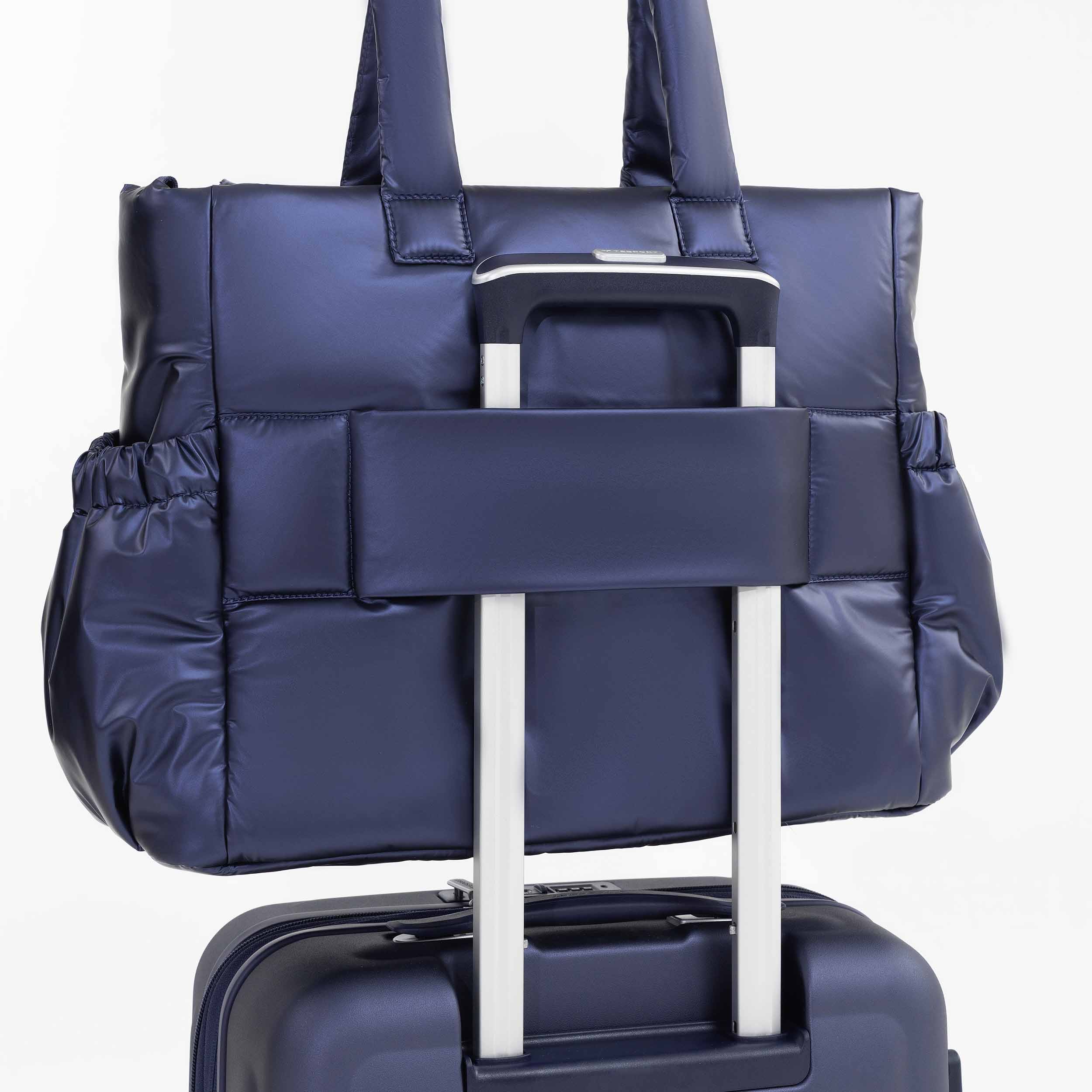 Tesport Cloud Tote in Navy on top of other luggage