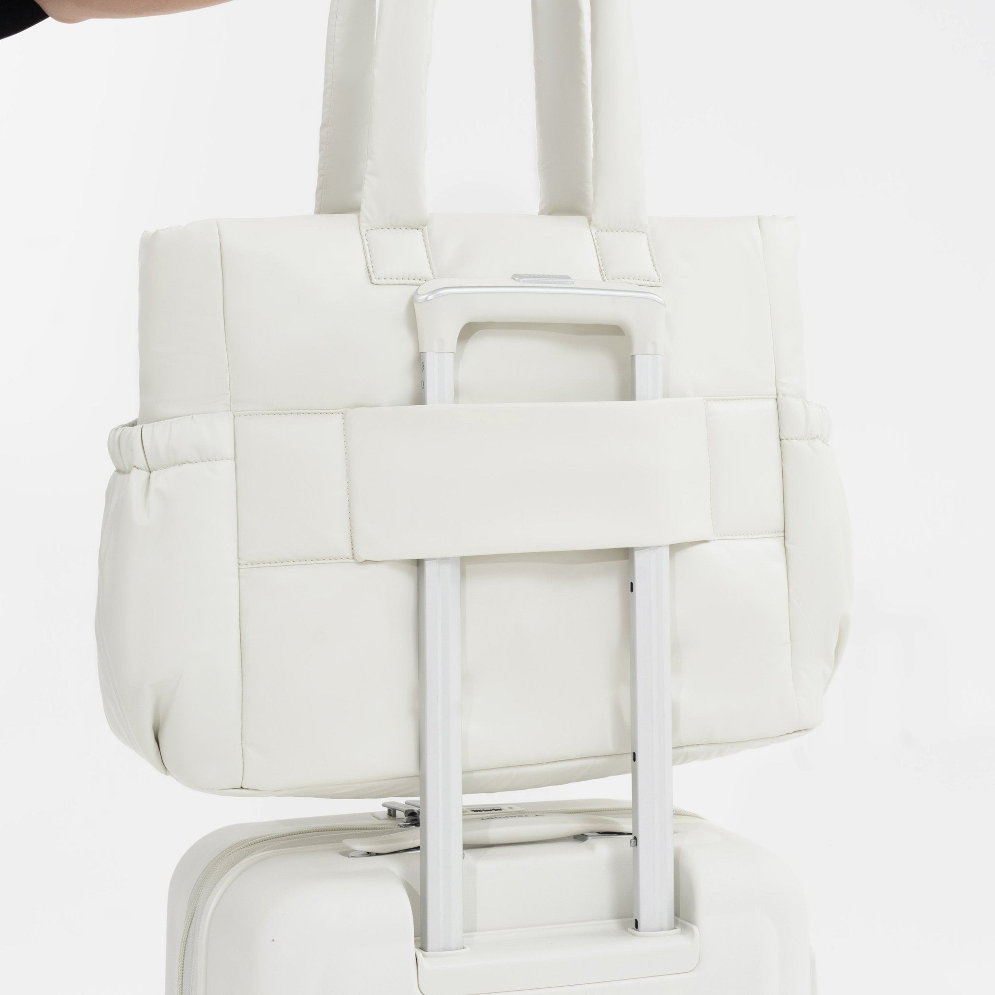 Tesport Cloud Tote in White on top of other luggage