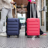 Tesport Cloud Flex Carry-On Luggage with male and female rolling backs in navy and pink