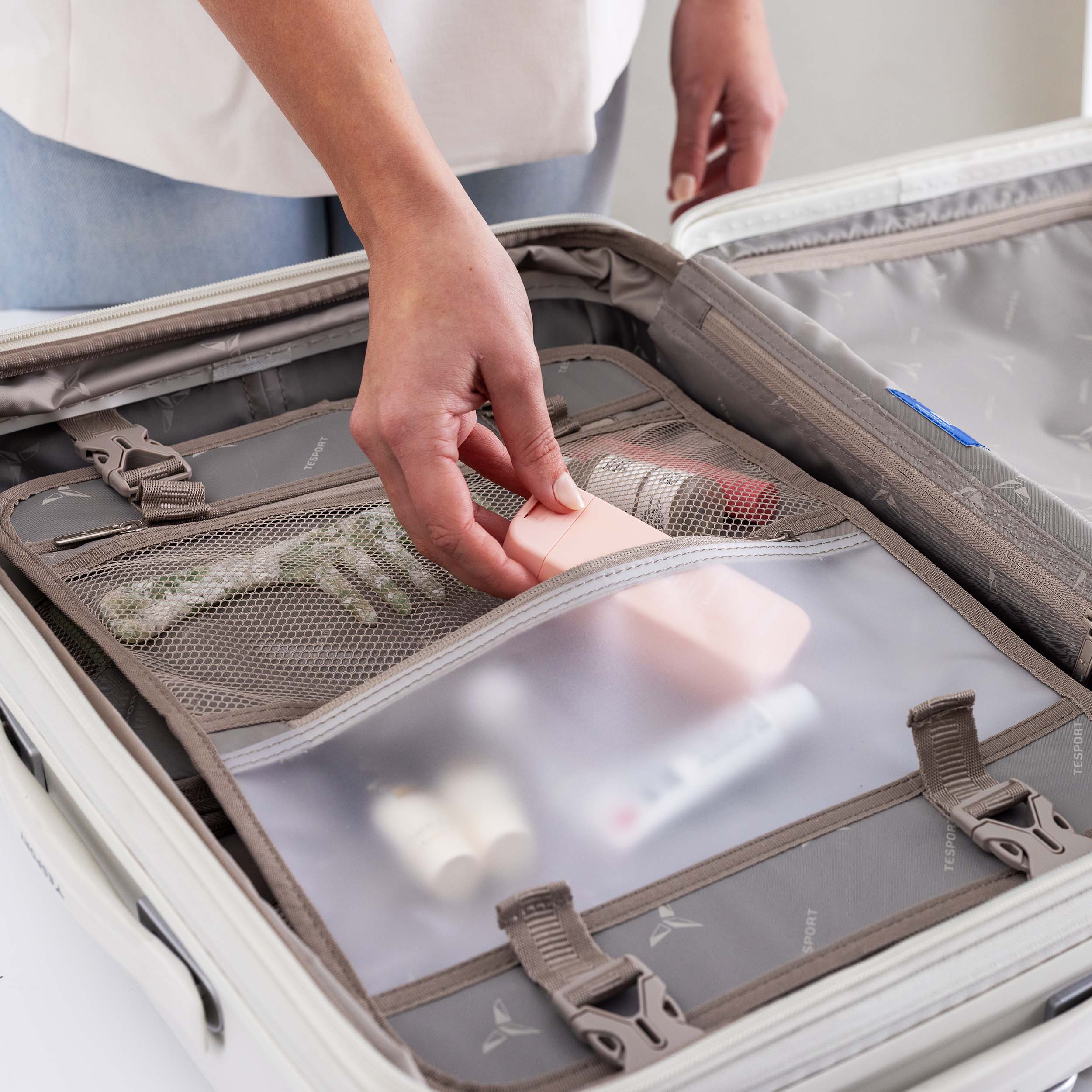 Person packing a Tesport Cloud Collection suitcase with a travel organizer