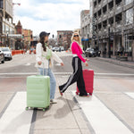 Cloud Large Check-In - In Apple Green with Pink, two women crossing the road smiling.