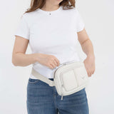 Tesport Cloud Crossbody Belt Bag in White female model unzipping
