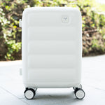Tesport Cloud Flex Carry-On Luggage in White outdoor lifestyle shot