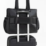 Tesport Cloud Tote in Black on top of other luggage