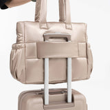 Tesport Cloud Tote in Champagne on top of other luggage