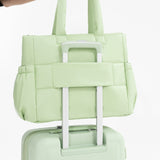 Tesport Cloud Tote in Apple Green on top of other luggage