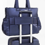 Tesport Cloud Tote in Navy on top of other luggage