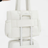 Tesport Cloud Tote in White on top of other luggage